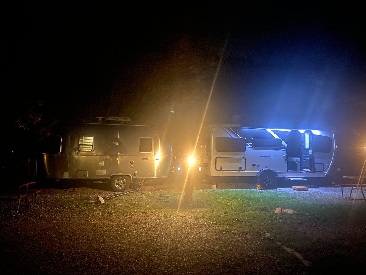 Travel trailers at a campground at night